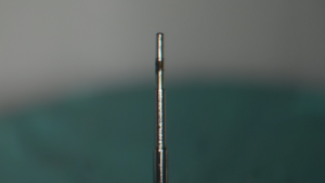 Damaged Rolex movement pivot requiring specialist repair
