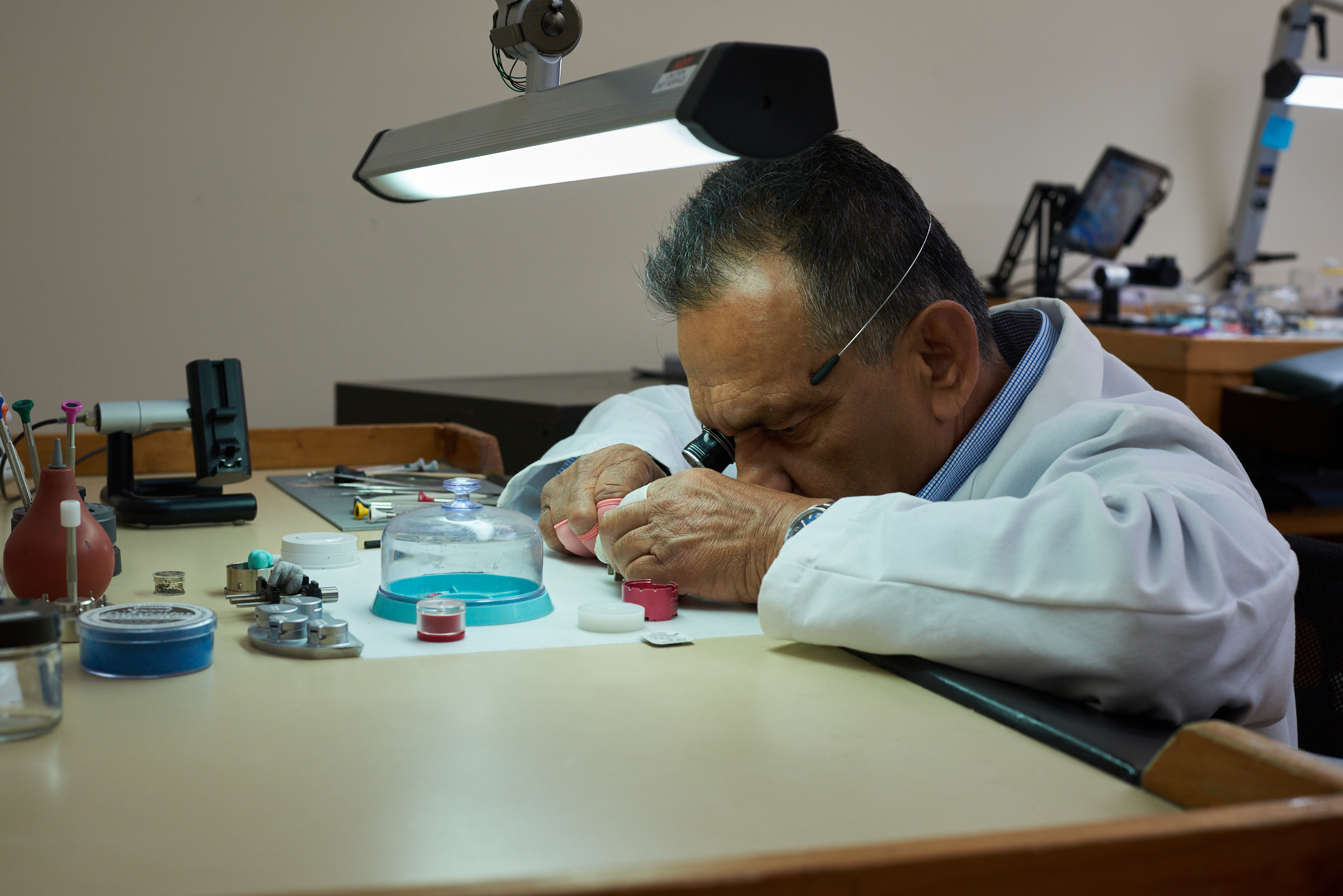 Technician performing professional watch battery replacement