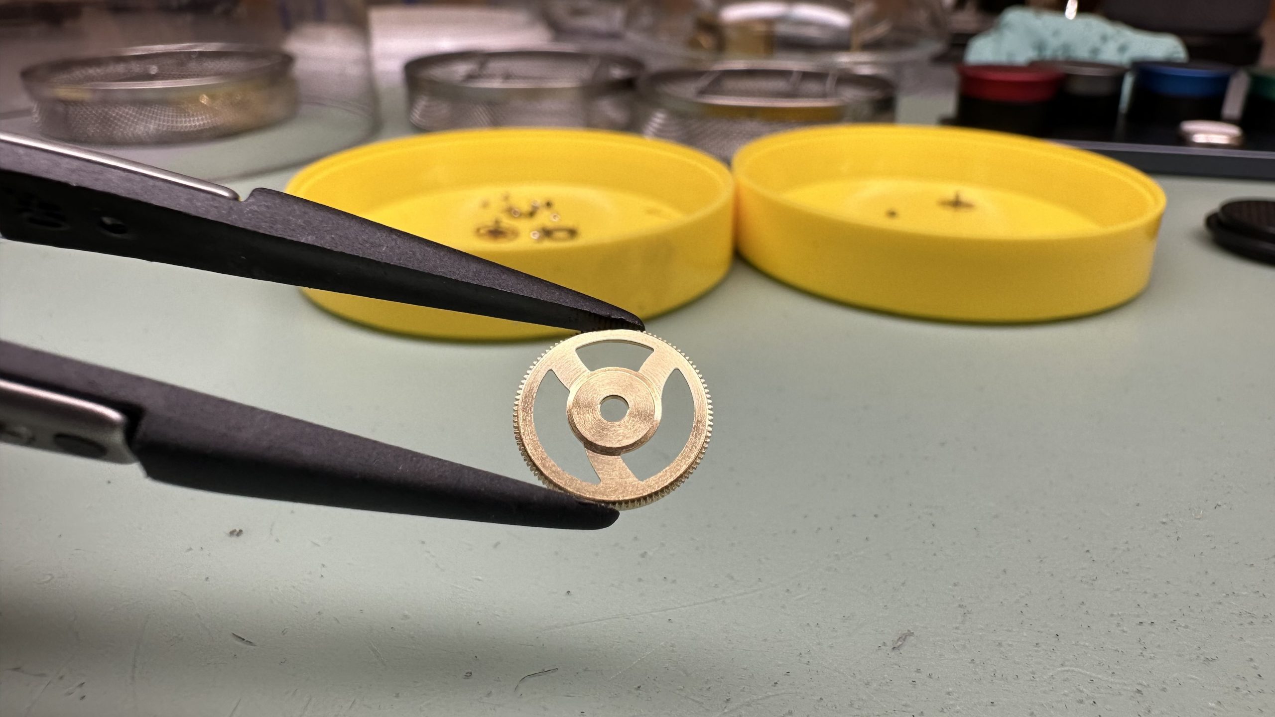 A professional watchmaker performing precision repairs on a luxury timepiece in an Atlanta workshop.