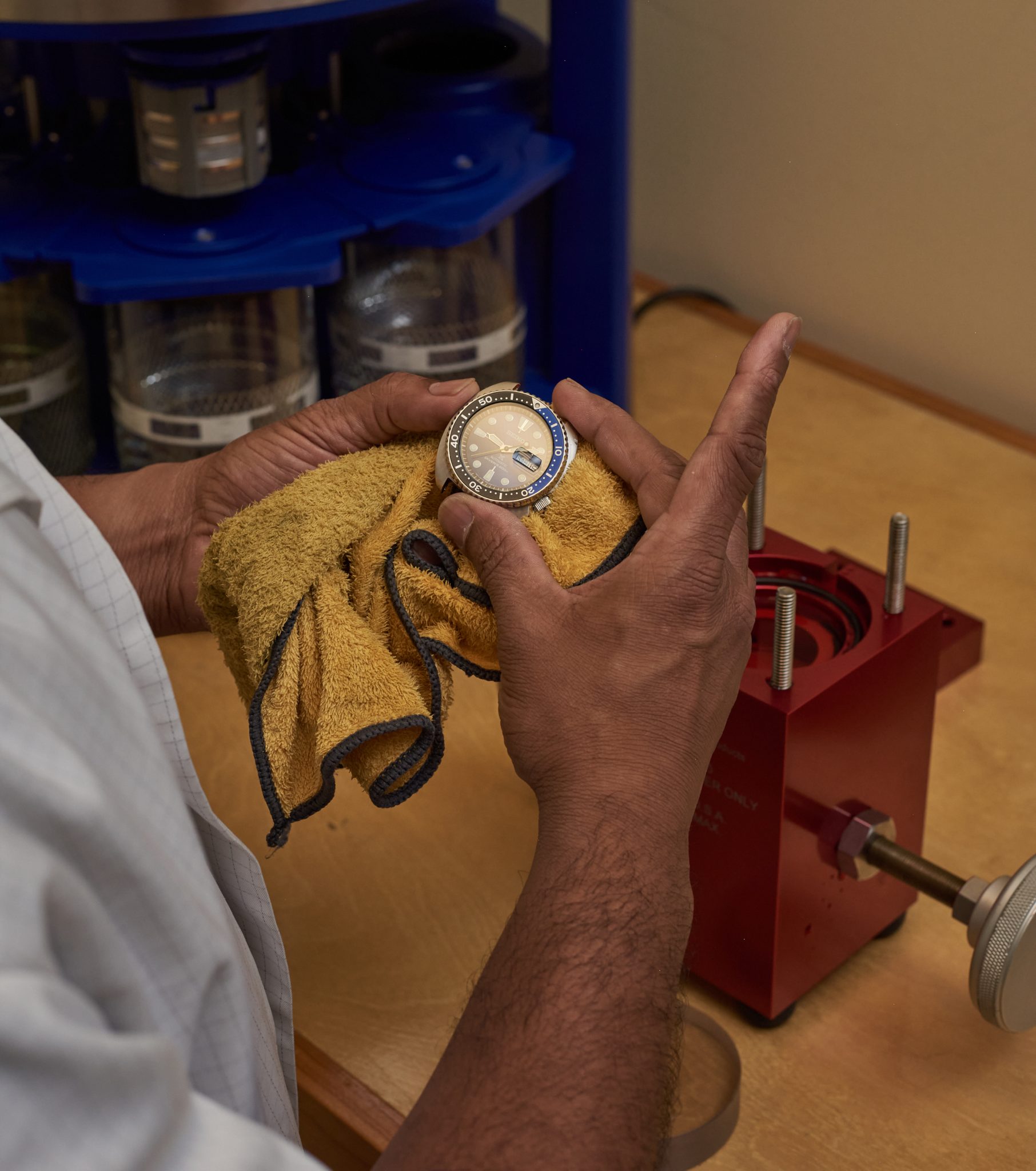 Hands holding a watch in the workshop