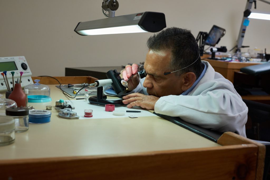 Certified watchmaker working at a dedicated repair bench