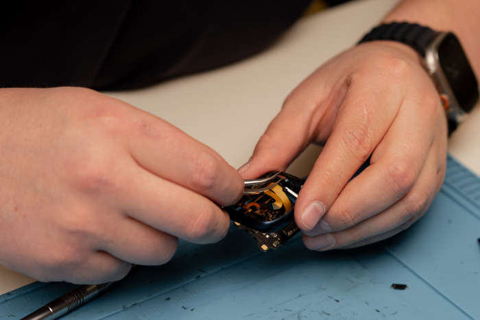 Watchmaker replacing a battery from the legacy Suwanee battery-service page