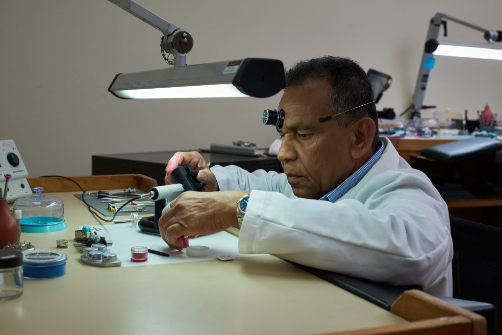 Watchmaker inspects a luxury watch